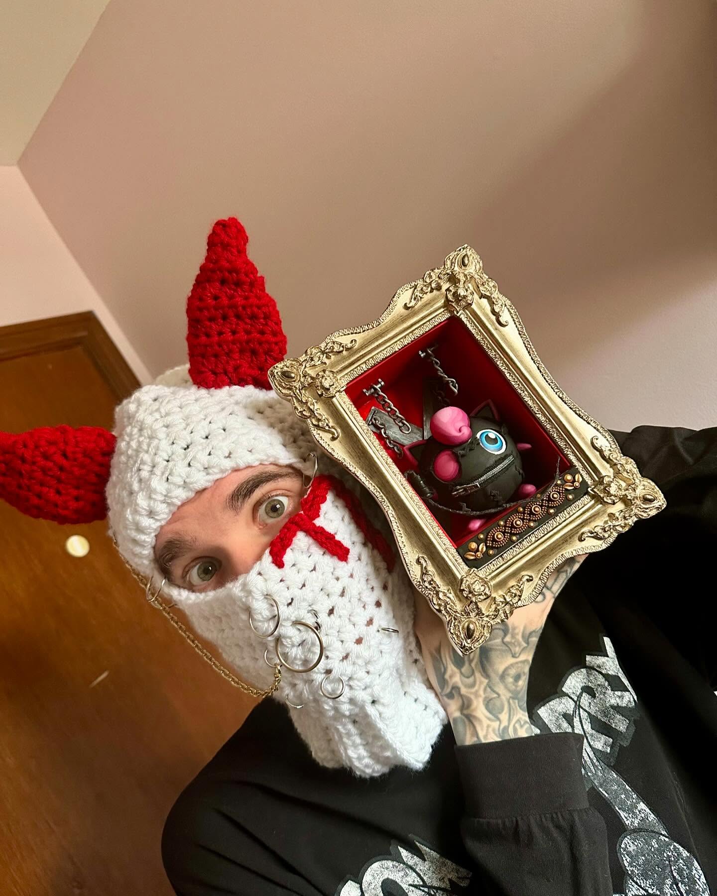 Hobby Hub World creator holding a framed art piece