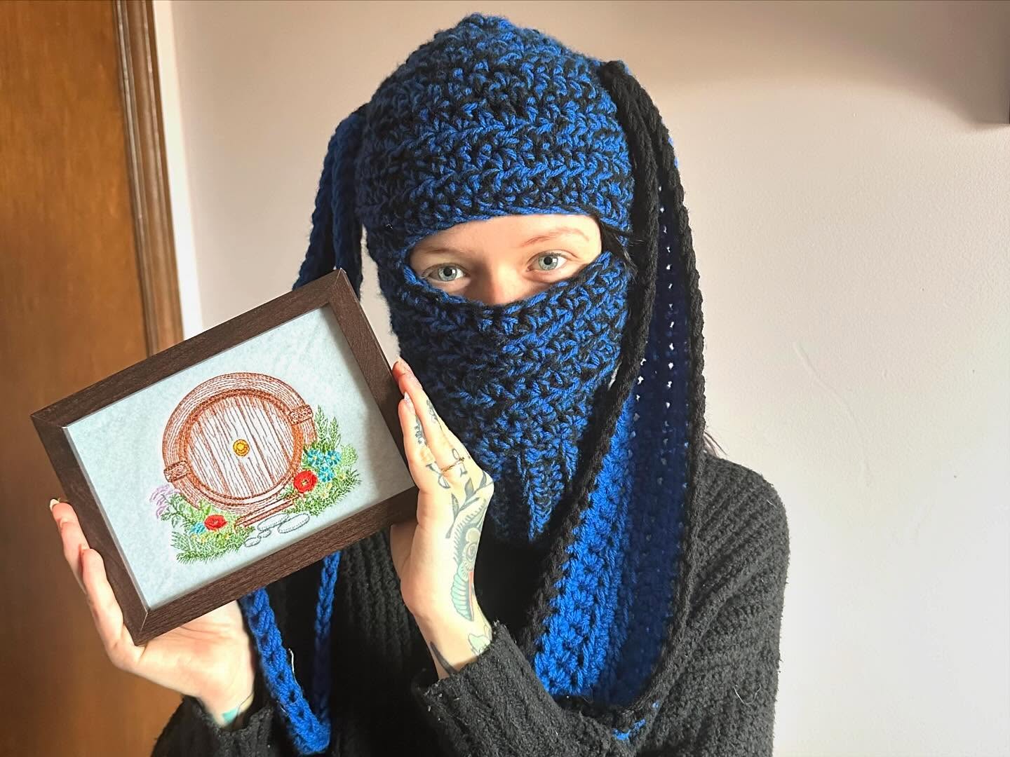 Hobby Hub World crafter holding a framed art piece